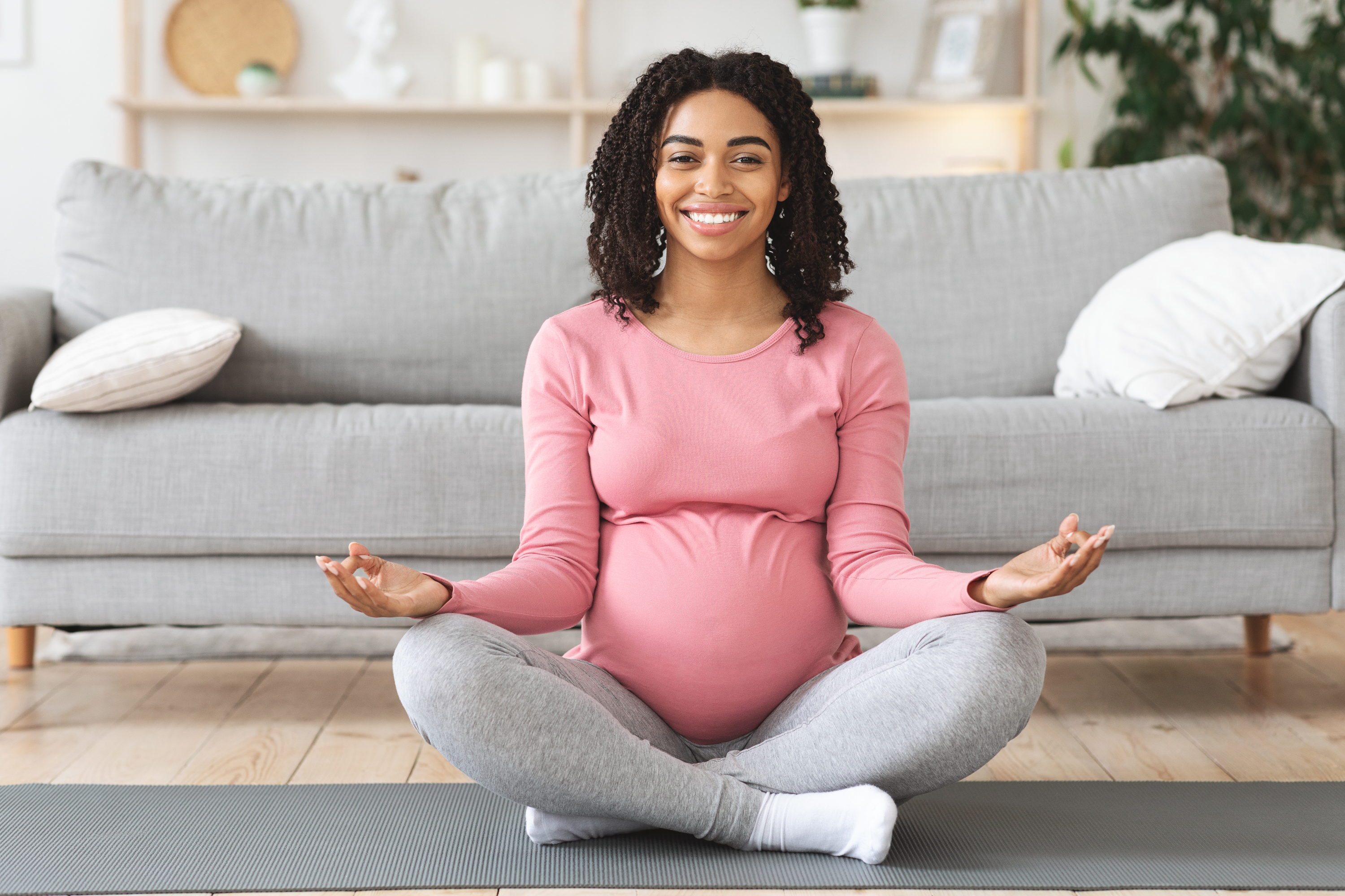 happy-black-expecting-lady-meditating-at-home-2022-10-07-01-27-58-utc